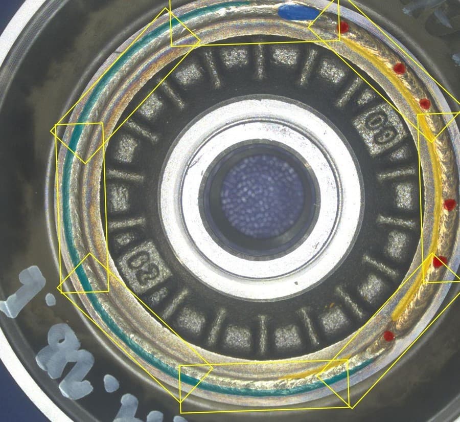 Automotive Weld Defect Segmentation · Every Defect Painted at Pixel Level Automotive Weld Defect Segmentation · Every Defect Painted at Pixel Level - Automotive case study image showing one ov20i image covers the full weld ring and separates porosity, weld displacement, and a doubled bead at pixel level, then grades the part against pixel-count rules with no external lighting. every weld defect in the trial was identified on a single recipe, 60 minutes from setup to first detection.