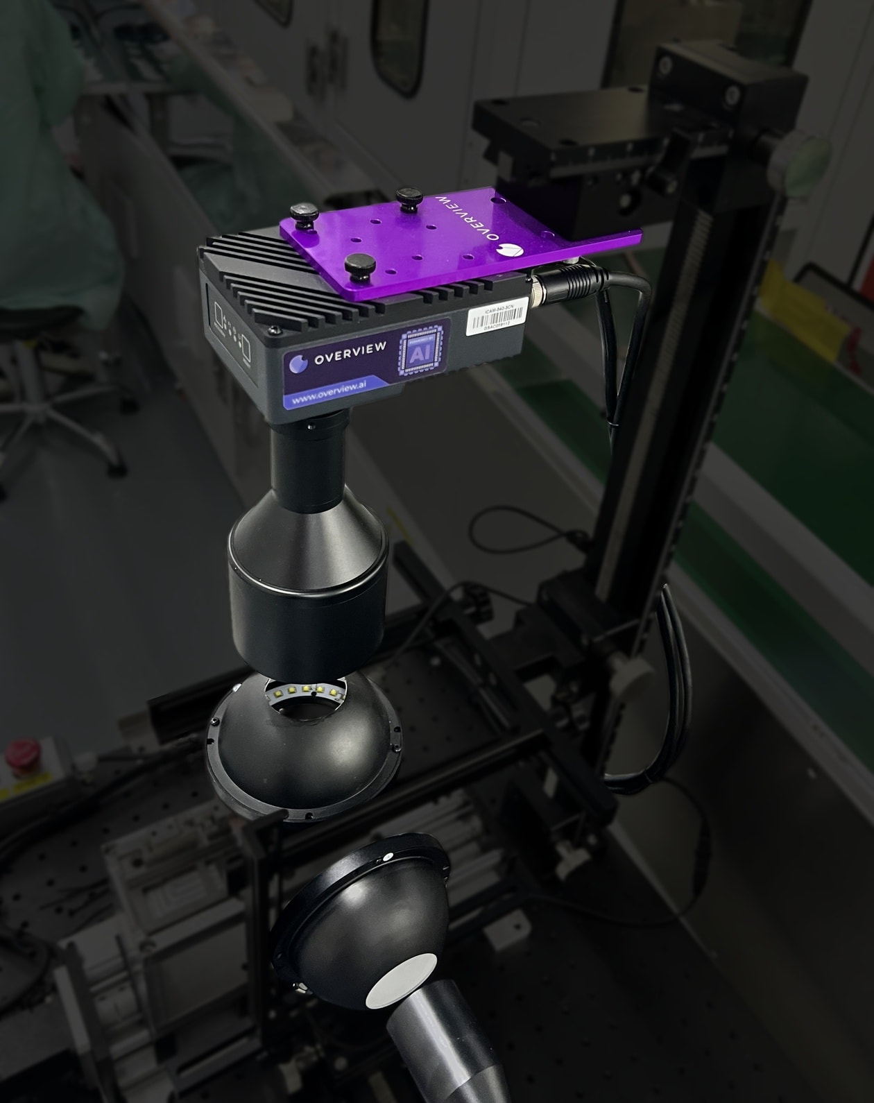 An Overview smart camera on a precision mount with dome lighting, imaging a small optical component